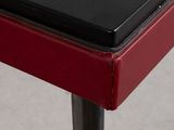 a close up of a red table with a black top