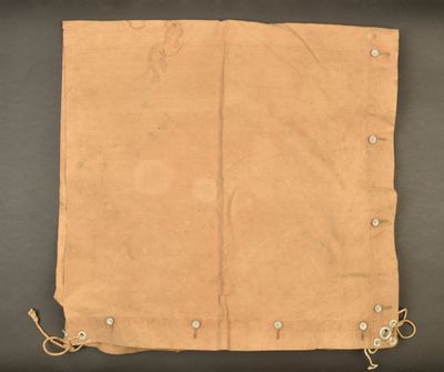 an old piece of tan cloth with small holes on it