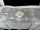 a bed with a white comforter and a white blanket on top of it