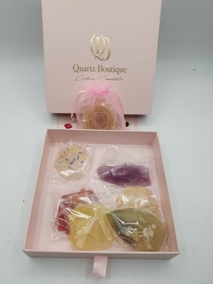 a pink box with a variety of candies in it