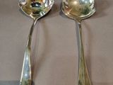 two spoons that are sitting on a table
