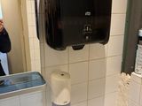 un homme en train de prendre une photo de toilettes dans des sanitaires publics