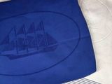 a blue towel with a picture of a ship on it