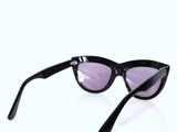 sunglasses with black frames and purple lenses on a white surface