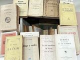 a lot of books that are stacked on top of each other