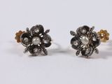 a pair of black and white diamond and pearl flower earrings