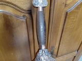 a knife that is sitting on top of a wooden chair