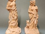 two statues of a woman and a man are standing next to each other