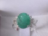 a picture of a ring with a green stone in it