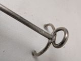 a pair of scissors hanging from a hook on a table