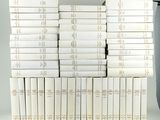 many books stacked on top of each other on a shelf