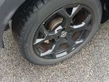 a close up of a car ' s tire on a gravel road