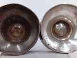 pair of silver plated bowls on stand on white surface