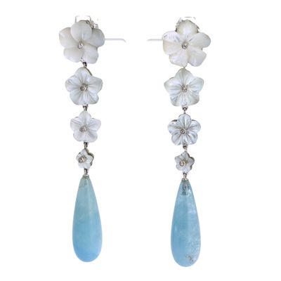 a close up of a pair of earrings with flowers on them