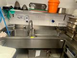 a kitchen with a sink and a stove in it