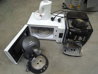 a microwave and a coffee maker sitting on the floor