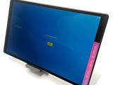 a tablet computer with a blue screen on a stand