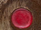 a close up of a vase with a red button on it
