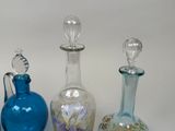 three glass vases sitting next to each other on a table