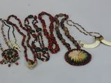 several necklaces and pendants are displayed on a table