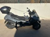 a scooter parked in a parking lot with a helmet on it