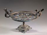 une assiette en argent ornée d'un motif représentant un dragon