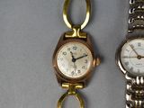 two watches sitting next to each other on a table