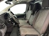 the interior of a car with a grey seat cover and a steering wheel