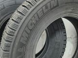 two tires are stacked on top of each other on a white surface