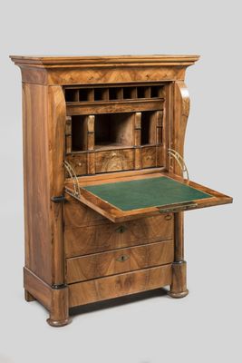 an old wooden desk with a green top and drawers