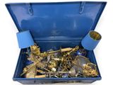 a blue suitcase filled with lots of gold and silver items