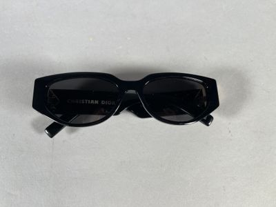 a pair of black sunglasses sitting on top of a white table