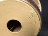 a close up of a vase with a hole in it