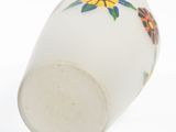 a close up of a white vase with a sunflower design