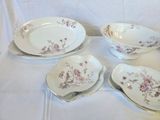 four plates and a bowl sitting on a table
