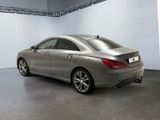 the back of a silver mercedes cla parked in a garage
