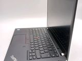 a laptop with a black keyboard on a white surface