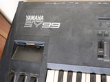 a black electronic keyboard sitting on top of a wooden table
