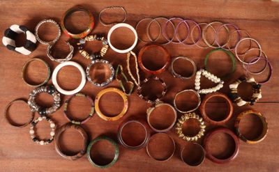 beaucoup de bracelets posés sur une table en bois