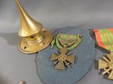 a lot of medals and a hat on a table