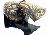 a wooden box with a black and gold design on it