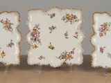 three plates that have been decorated with flowers on them
