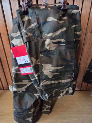 camouflage cargo pants with a red tag on the side