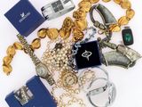 a lot of jewelry that is laying out on the table