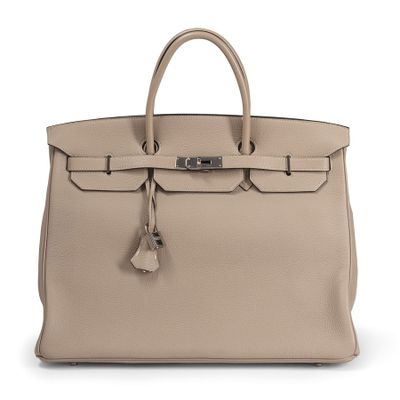 a beige leather handbag on a white background