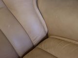 a close up view of a tan leather couch