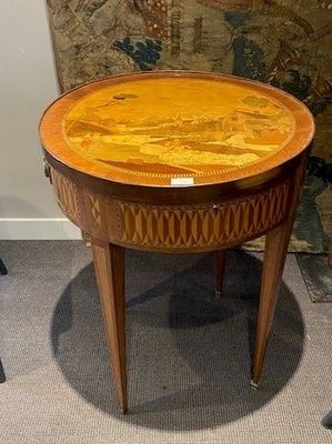 a small table with a wooden top on a carpeted floor