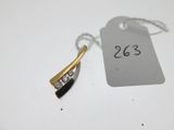 a close up of a tag on a white table with a pair of earrings on it