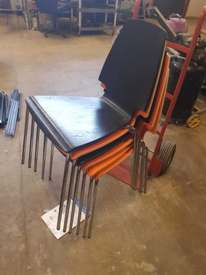 many chairs that are stacked on top of each other