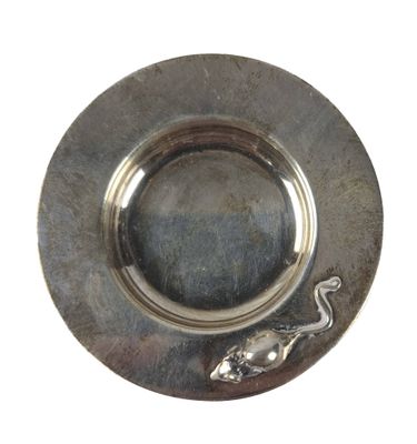a silver plate with a lizard on it on a white background